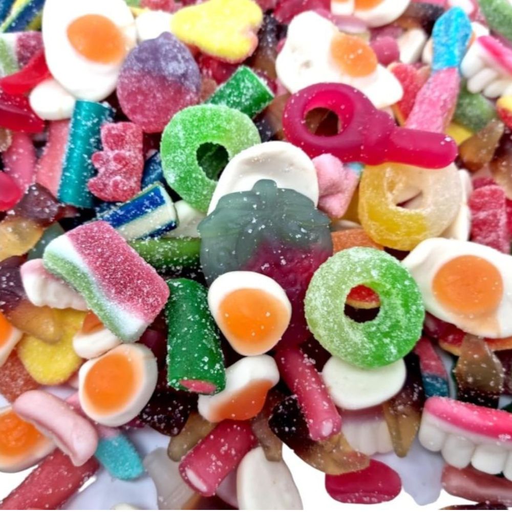 Assorted colorful gummy candies on a white background