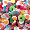 Assorted colorful gummy candies on a white background