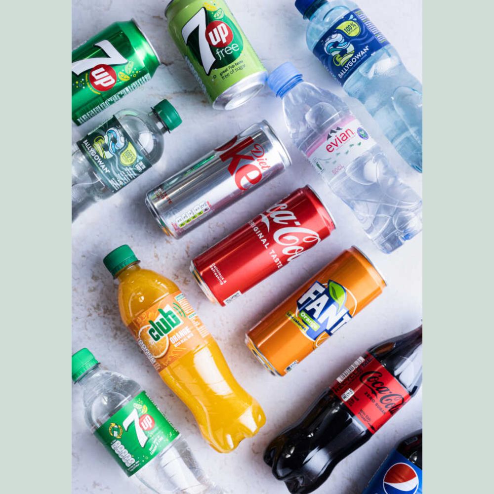 Collection of various soda and water bottles on a light background