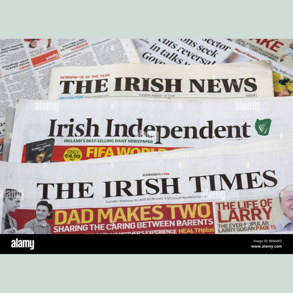 Stack of Irish newspapers including 'The Irish News', 'Irish Independent', and 'The Irish Times'.